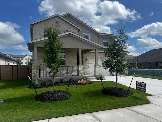 512 Raleigh Dr, Georgetown, TX 78633 - view of front of home with covered porch, concrete driveway, stone siding, an attached garage, and brick siding