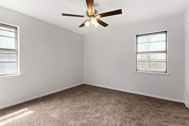 spare room featuring baseboards, ceiling fan, and carpet flooring