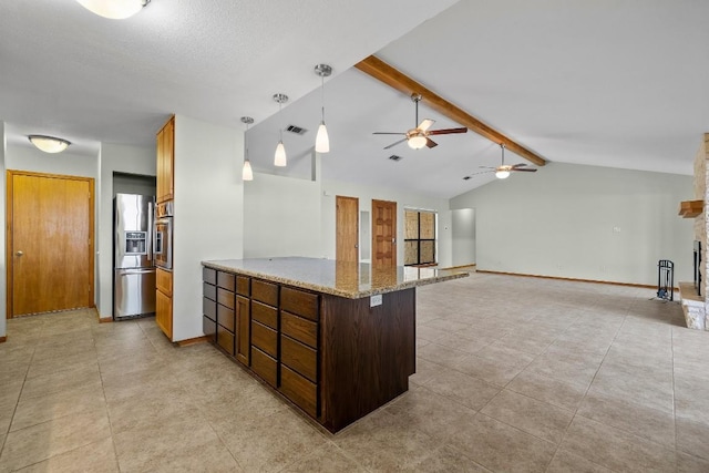 209 Senisa Dr, Buchanan Dam, TX 78609 - kitchen with light stone counters, a ceiling fan, lofted ceiling with beams, stainless steel appliances, and visible vents