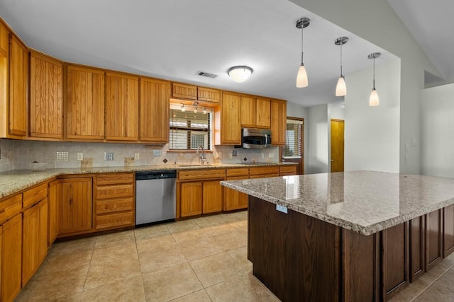 209 Senisa Dr, Buchanan Dam, TX 78609 - kitchen with visible vents, tasteful backsplash, appliances with stainless steel finishes, a sink, and light tile patterned floors