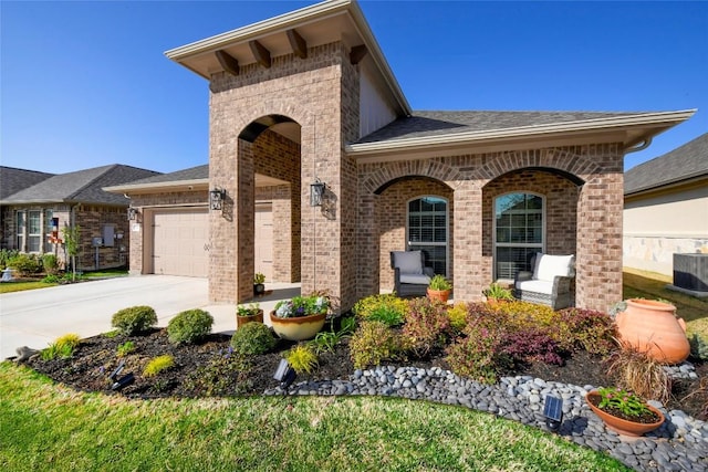 5314 Tribolo Trl, Round Rock, TX 78665 - view of front of property with brick siding, driveway, a garage, and a shingled roof