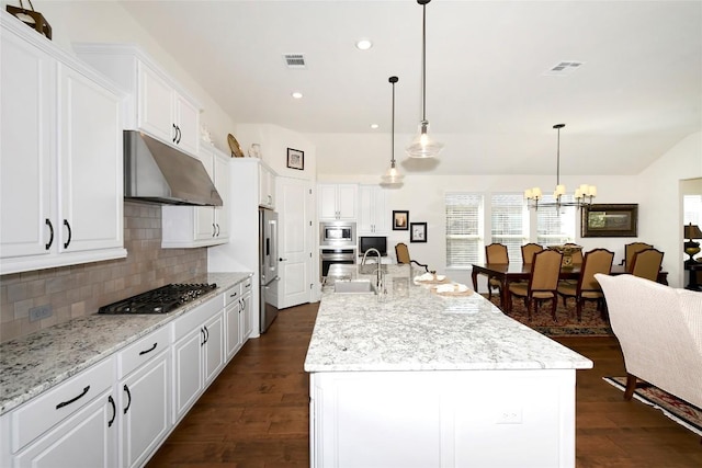 5314 Tribolo Trl, Round Rock, TX 78665 - kitchen featuring under cabinet range hood, stainless steel appliances, decorative backsplash, dark wood-type flooring, and recessed lighting