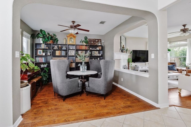 105 Wimberley St, Hutto, TX 78634 - tiled dining space with a ceiling fan, healthy amount of natural light, and arched walkways