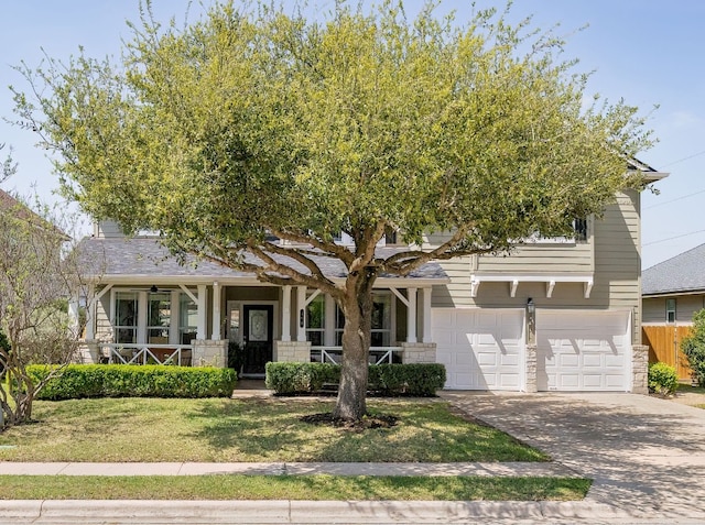 105 Wimberley St, Hutto, TX 78634 - view of front of property with covered porch, driveway, an attached garage, and a front lawn