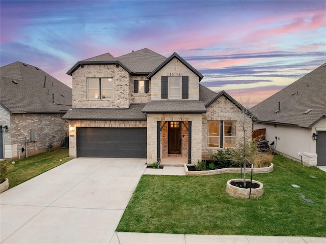 1017 Dog Iron St, Georgetown, TX 78633 - french country inspired facade with roof with shingles, an attached garage, and brick siding