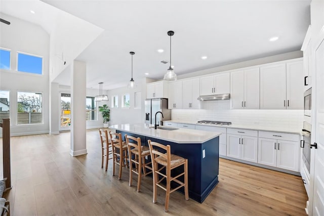 1017 Dog Iron St, Georgetown, TX 78633 - kitchen featuring stainless steel fridge, gas stovetop, recessed lighting, an island with sink, and tasteful backsplash
