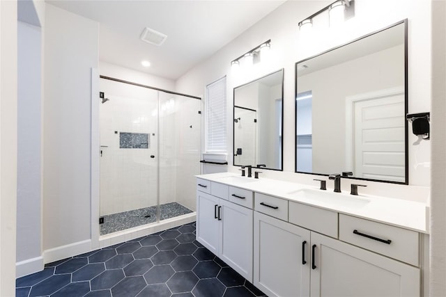 1017 Dog Iron St, Georgetown, TX 78633 - full bathroom with tile patterned floors, double vanity, a shower stall, and recessed lighting