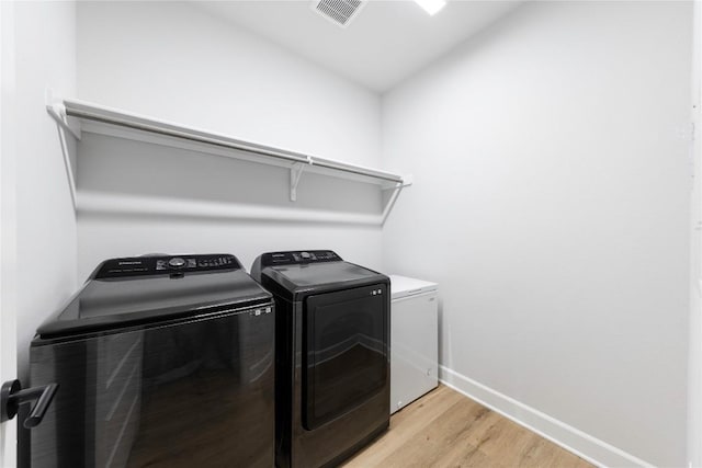 1017 Dog Iron St, Georgetown, TX 78633 - washroom featuring separate washer and dryer and light wood-style flooring