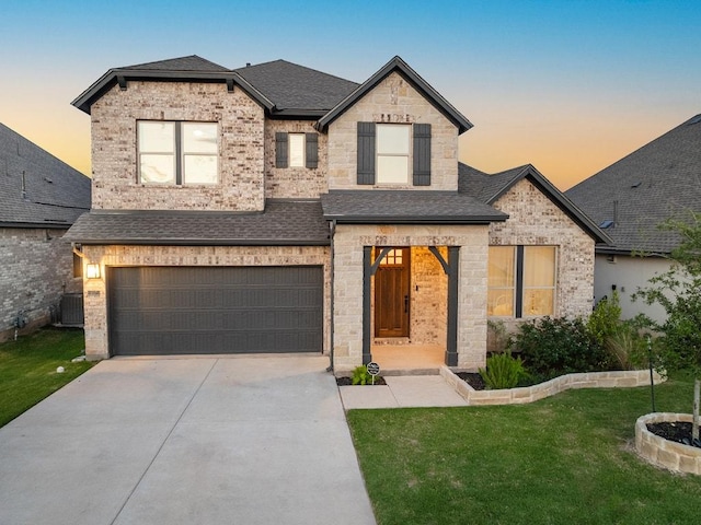 1017 Dog Iron St, Georgetown, TX 78633 - french country home with a front yard, an attached garage, concrete driveway, and a shingled roof