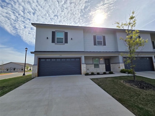 2105 Tiger Trl Unit 501, Round Rock, TX 78665 - view of front of property with stone siding, driveway, a garage, and stucco siding