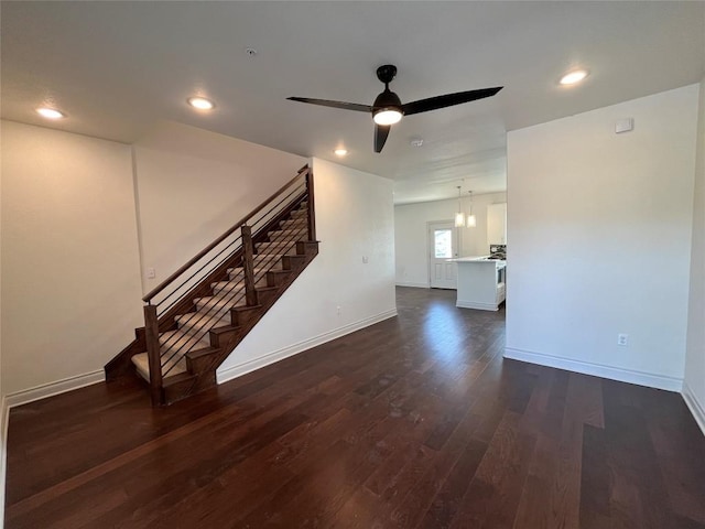 2105 Tiger Trl Unit 501, Round Rock, TX 78665 - unfurnished living room featuring dark wood finished floors, baseboards, ceiling fan, and stairway
