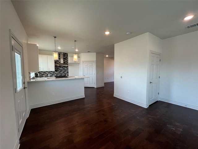 2105 Tiger Trl Unit 501, Round Rock, TX 78665 - kitchen with light countertops, visible vents, dark wood-type flooring, wall chimney range hood, and backsplash