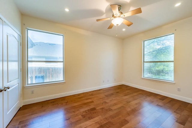 7724 Yaupon Dr, Austin, TX 78759 - unfurnished room with wood finished floors, plenty of natural light, baseboards, and recessed lighting