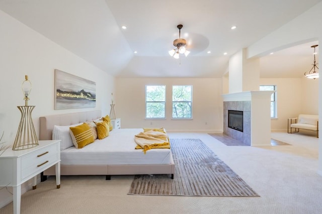 7724 Yaupon Dr, Austin, TX 78759 - bedroom featuring light colored carpet, vaulted ceiling, a fireplace, recessed lighting, and baseboards