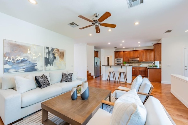 7724 Yaupon Dr, Austin, TX 78759 - living area with a ceiling fan, light wood-type flooring, recessed lighting, and stairs