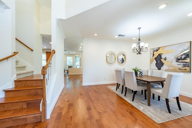 7724 Yaupon Dr, Austin, TX 78759 - dining space featuring stairs, a chandelier, wood finished floors, crown molding, and recessed lighting