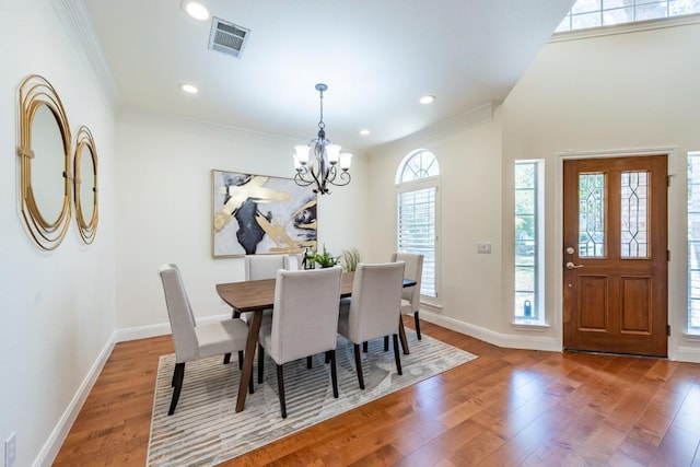 7724 Yaupon Dr, Austin, TX 78759 - dining room with wood finished floors, a chandelier, ornamental molding, baseboards, and recessed lighting