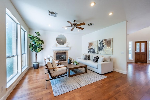 7724 Yaupon Dr, Austin, TX 78759 - living room with plenty of natural light, light wood-style floors, a fireplace, baseboards, and recessed lighting