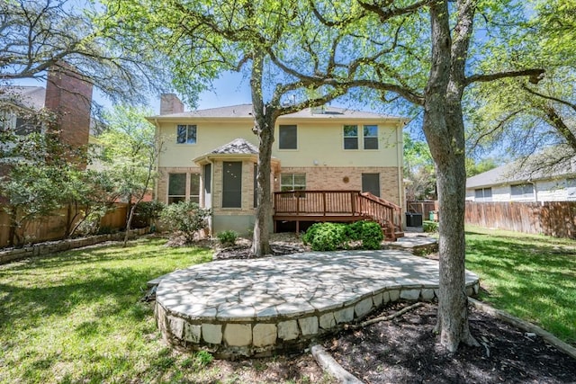 7724 Yaupon Dr, Austin, TX 78759 - rear view of property featuring brick siding, a wooden deck, a fenced backyard, a patio, and a chimney