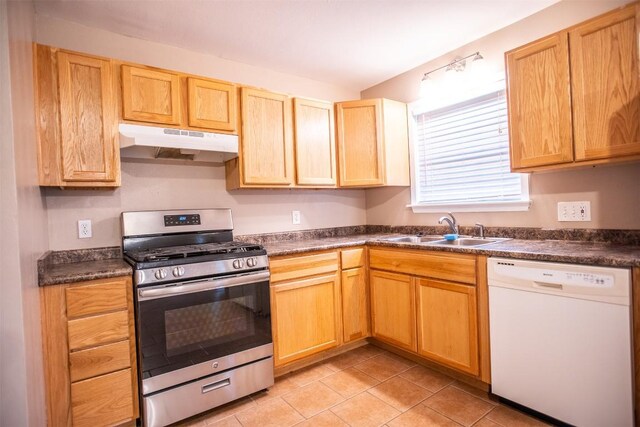2312 Devonshire Dr, Austin, TX 78723 - kitchen featuring dishwasher, under cabinet range hood, stainless steel gas stove, and dark countertops