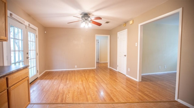 2312 Devonshire Dr, Austin, TX 78723 - unfurnished room with light wood-style floors, a ceiling fan, and french doors