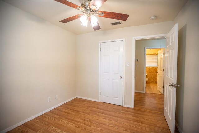 2312 Devonshire Dr, Austin, TX 78723 - unfurnished bedroom featuring light wood-type flooring and ceiling fan