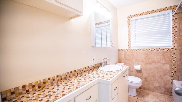 2312 Devonshire Dr, Austin, TX 78723 - bathroom featuring vanity, tile patterned floors, and tile walls