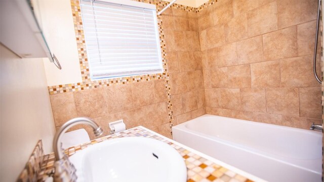 2312 Devonshire Dr, Austin, TX 78723 - full bathroom featuring shower / tub combination and tile walls