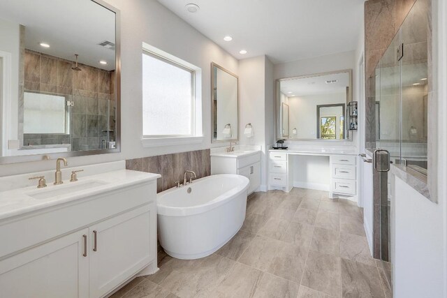 6109 Destination Way, Lago Vista, TX 78645 - bathroom featuring a shower stall, two vanities, a soaking tub, and recessed lighting