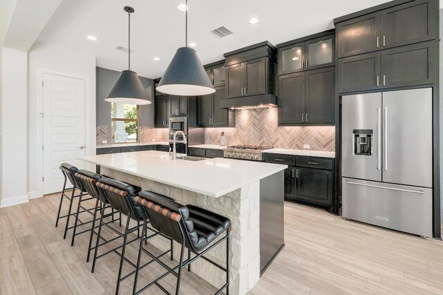 6109 Destination Way, Lago Vista, TX 78645 - kitchen with stainless steel appliances, light countertops, backsplash, pendant lighting, and recessed lighting
