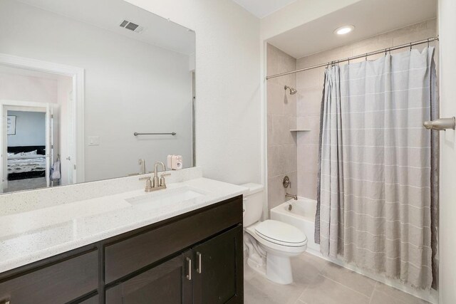 6109 Destination Way, Lago Vista, TX 78645 - bathroom featuring vanity, shower / bath combo with shower curtain, connected bathroom, and tile patterned floors