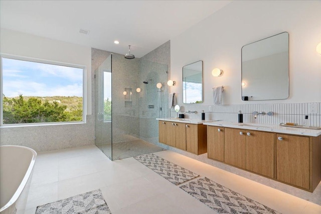 13400 Paisano Trl, Austin, TX 78737 - bathroom with vanity, a walk in shower, a freestanding tub, tile patterned flooring, and recessed lighting