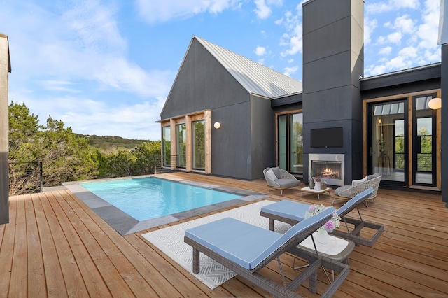 13400 Paisano Trl, Austin, TX 78737 - outdoor pool featuring a fireplace and a wooden deck