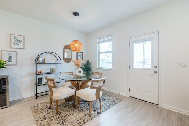 12305 Zenyatta Dr, Buda, TX 78610 - dining room featuring baseboards, light wood finished floors, and beverage cooler