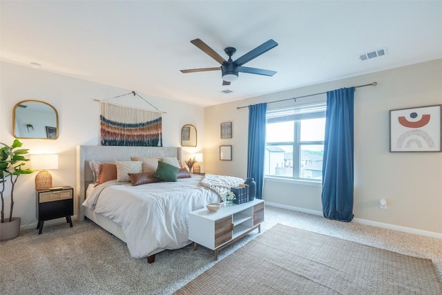carpeted bedroom featuring a ceiling fan, baseboards, and visible vents