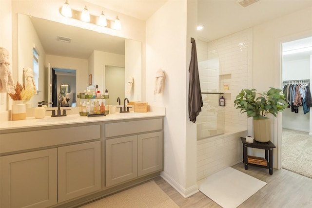12305 Zenyatta Dr, Buda, TX 78610 - full bath with a sink, tiled shower, double vanity, and visible vents