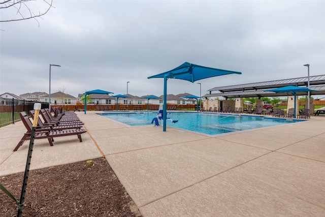 pool with a gazebo, a patio area, and fence