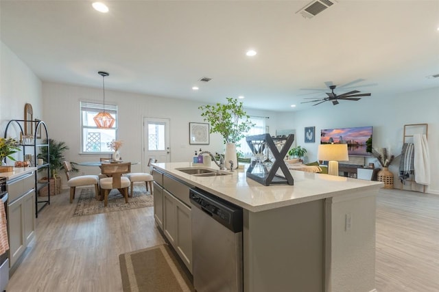 12305 Zenyatta Dr, Buda, TX 78610 - kitchen featuring a sink, a healthy amount of sunlight, stainless steel dishwasher, and visible vents