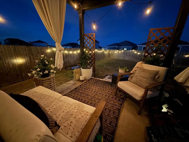 patio at twilight featuring a fenced backyard