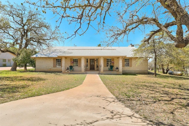 591 Young Ranch Rd, Georgetown, TX 78633 - ranch-style house featuring a porch, a chimney, a front yard, and metal roof