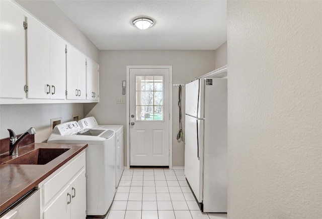 591 Young Ranch Rd, Georgetown, TX 78633 - washroom with separate washer and dryer, cabinet space, and light tile patterned floors