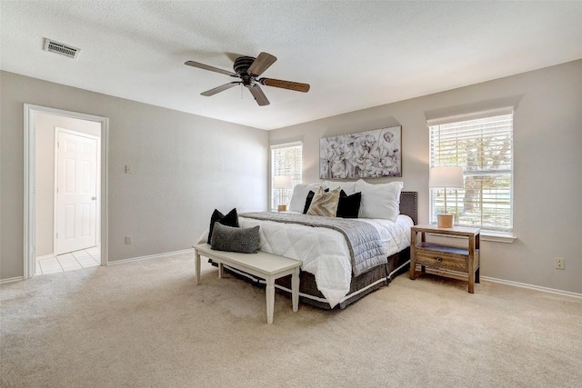 591 Young Ranch Rd, Georgetown, TX 78633 - bedroom with multiple windows, light carpet, baseboards, and ceiling fan