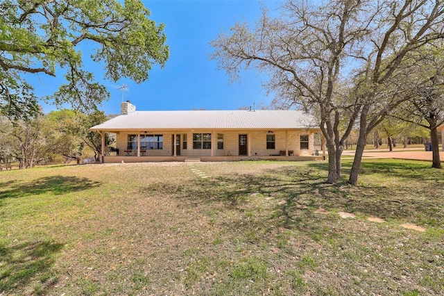 591 Young Ranch Rd, Georgetown, TX 78633 - view of front of home featuring a chimney, a front yard, and covered porch