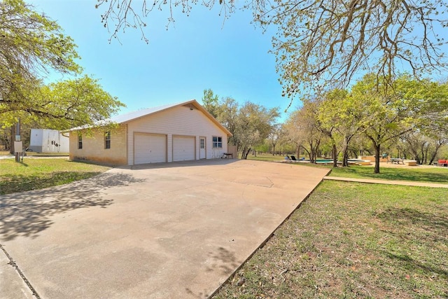 591 Young Ranch Rd, Georgetown, TX 78633 - view of property exterior with a yard, concrete driveway, and a garage