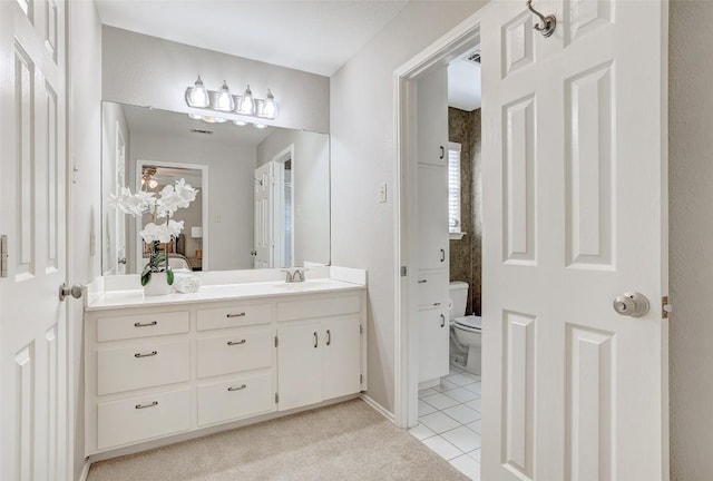 591 Young Ranch Rd, Georgetown, TX 78633 - bathroom with vanity, tile patterned floors, and toilet