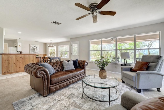 591 Young Ranch Rd, Georgetown, TX 78633 - living room featuring light colored carpet, a chandelier, ceiling fan, and baseboards