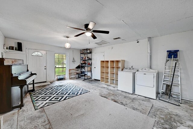 2511 Bitter Creek Dr, Austin, TX 78744 - miscellaneous room featuring washing machine and clothes dryer, a textured ceiling, and a ceiling fan