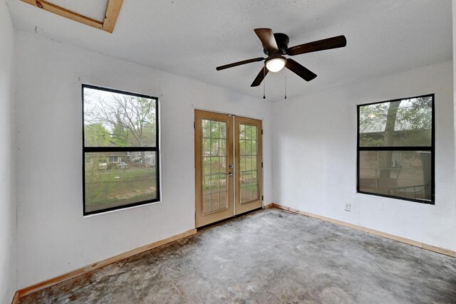 2511 Bitter Creek Dr, Austin, TX 78744 - unfurnished room featuring french doors, concrete floors, baseboards, and a ceiling fan