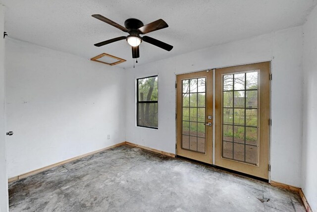 2511 Bitter Creek Dr, Austin, TX 78744 - unfurnished room with french doors, unfinished concrete flooring, baseboards, and ceiling fan