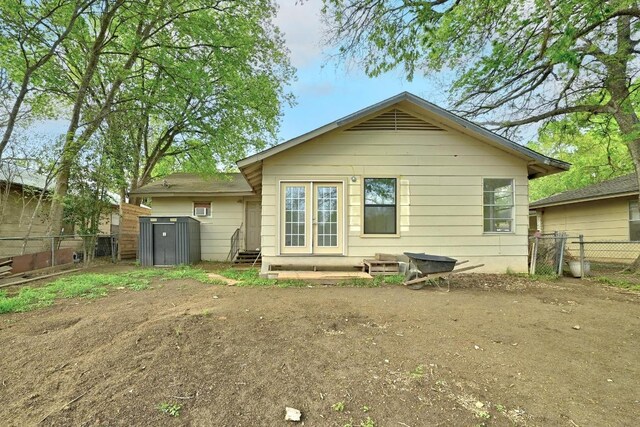 2511 Bitter Creek Dr, Austin, TX 78744 - back of house with a fenced backyard and entry steps